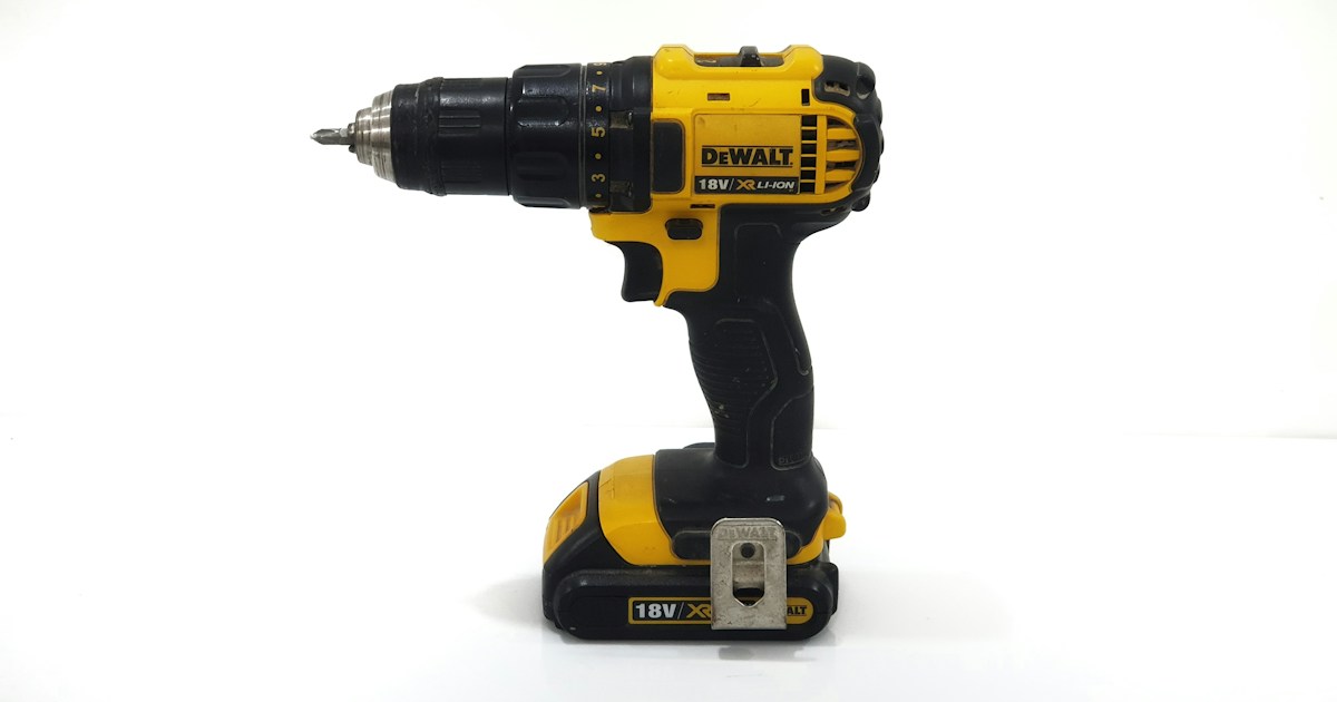 Yellow and black cordless drill on a white background.