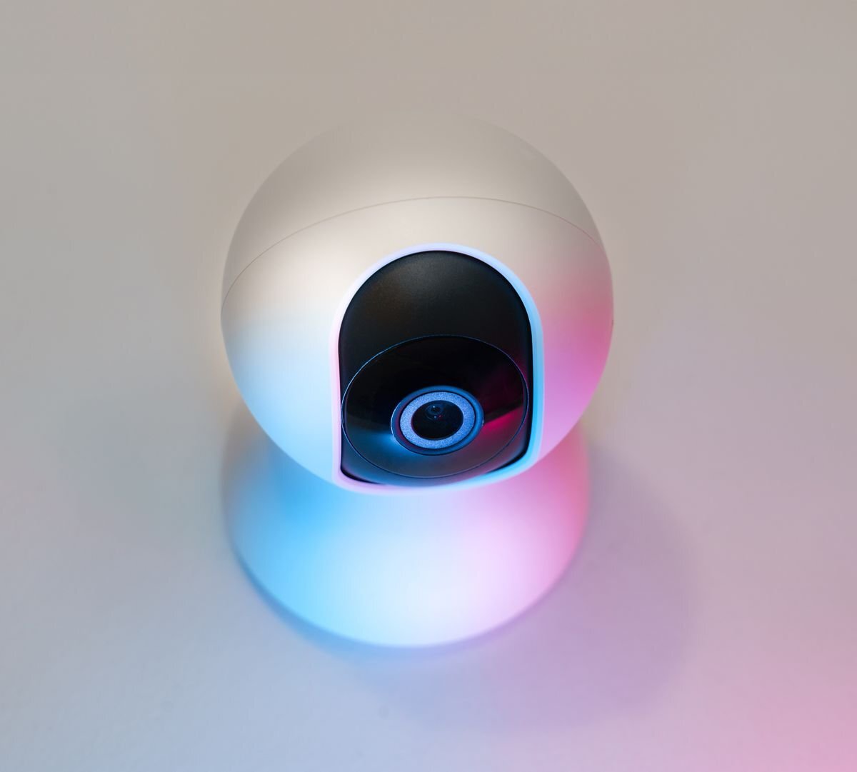 Close-up of a white home security camera lens